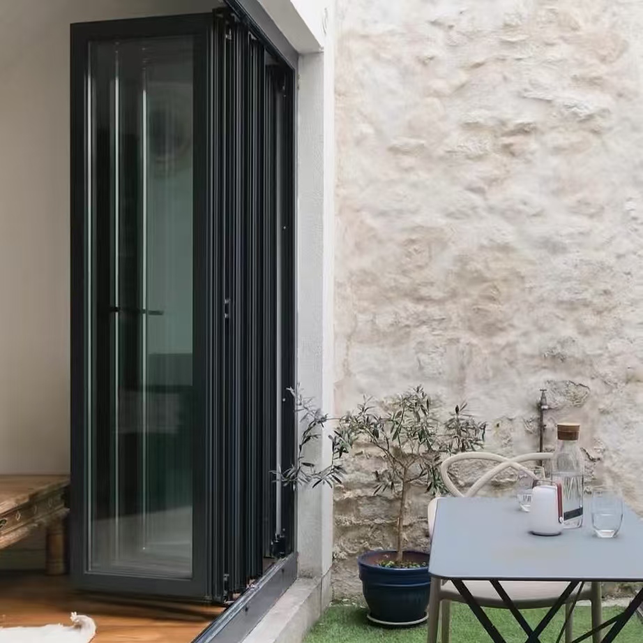 Orkaanbestendige, waterdichte aluminium buitendeur met minimalistisch design voor keuken, balkon of terras. Vouwdeur.